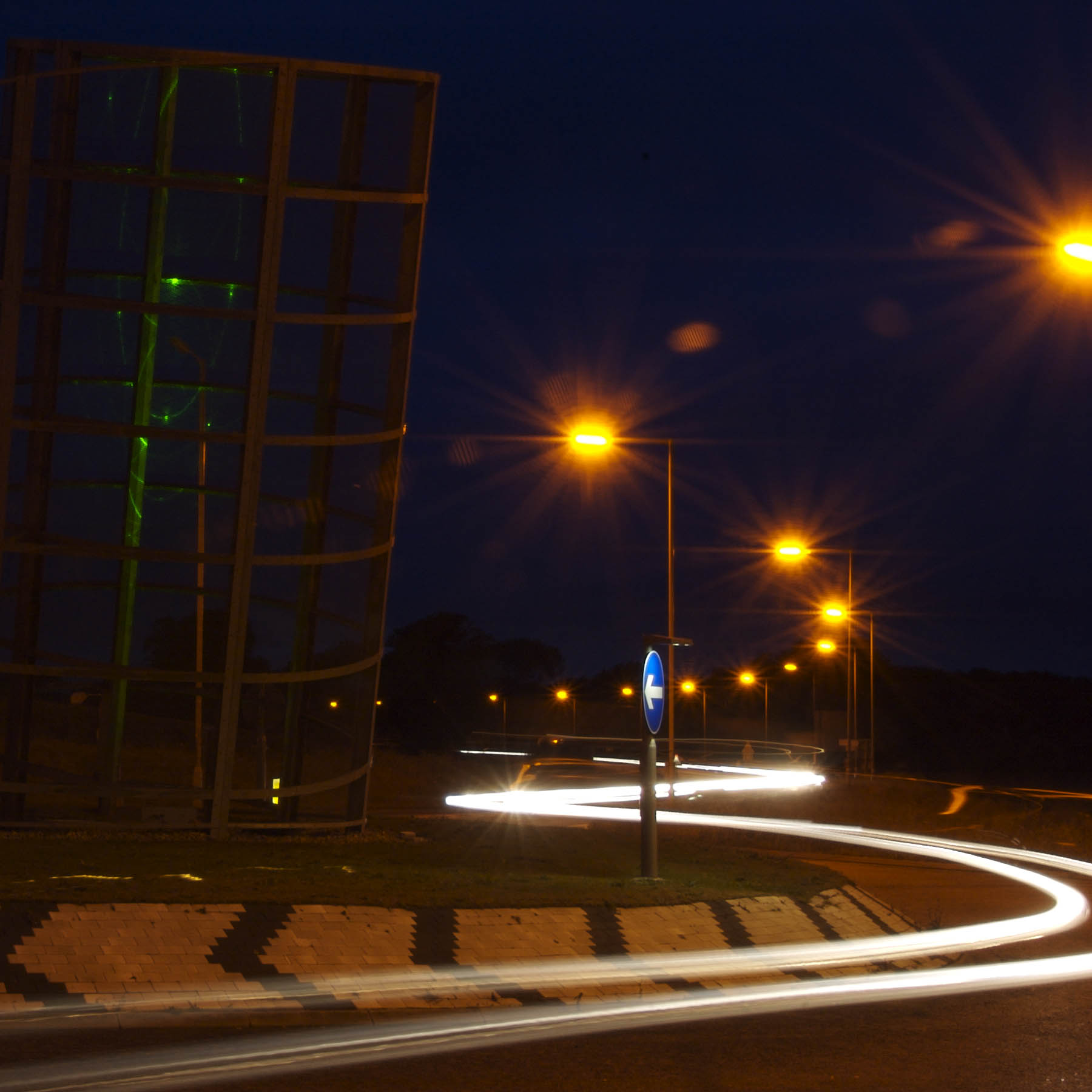 an image of night scene with cars passing by