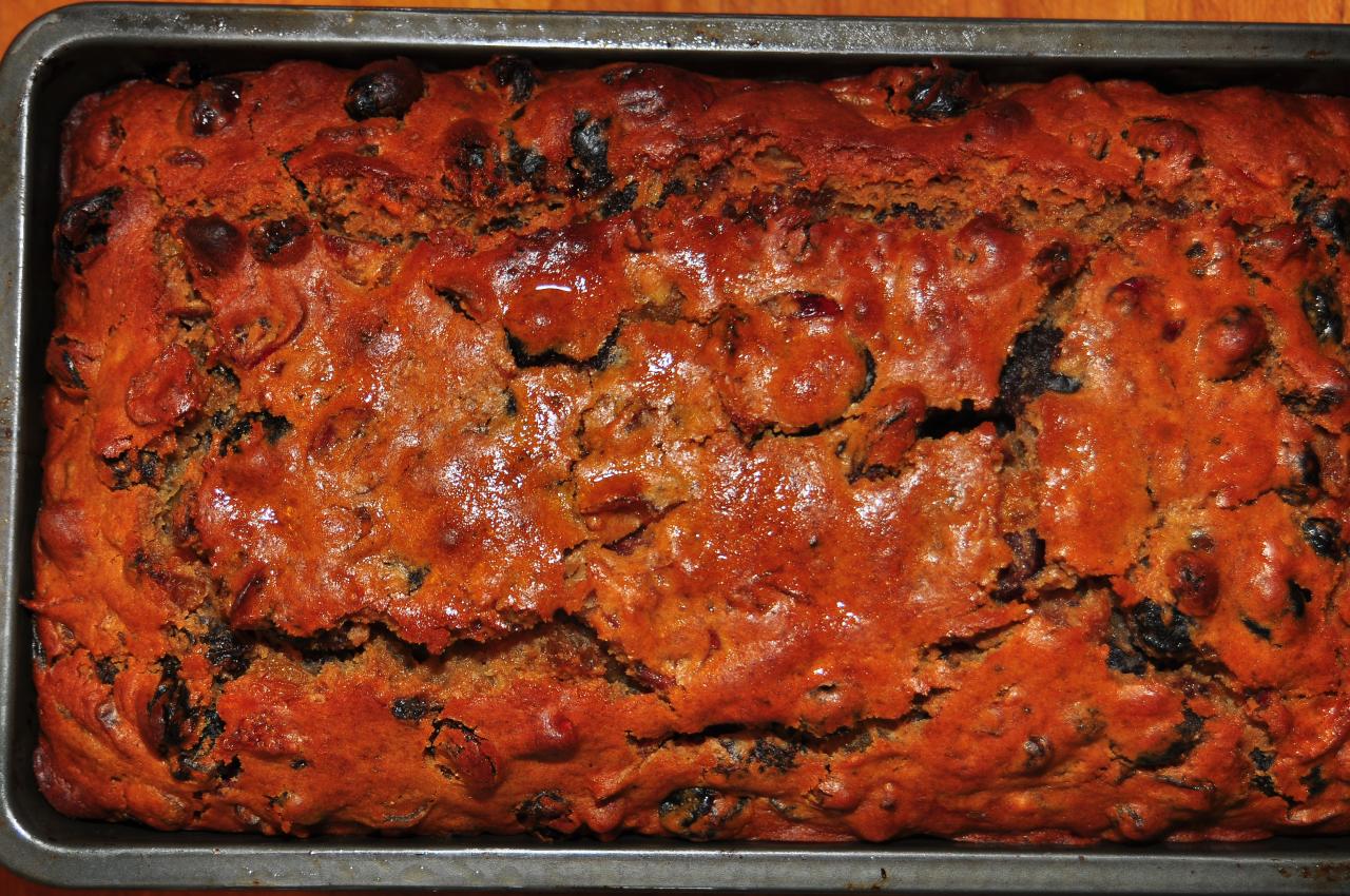 a large loaf of bread with tomatoes and olives on it