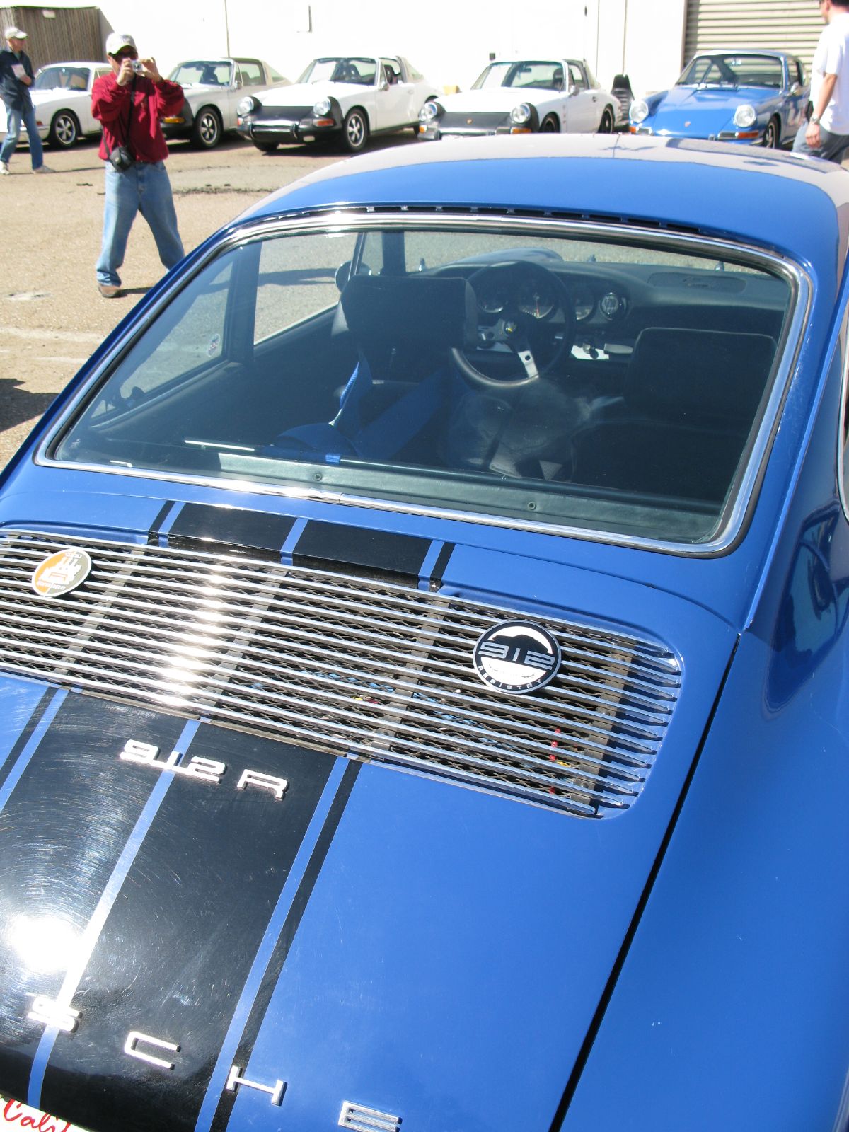 a blue car with a dog in the passenger seat