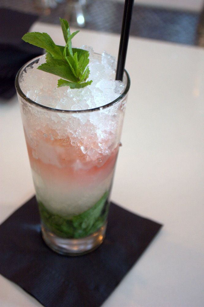 a glass of ice tea with a mint garnish