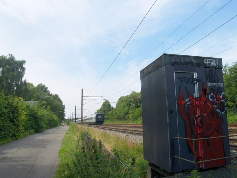 train on the tracks passing through the green countryside