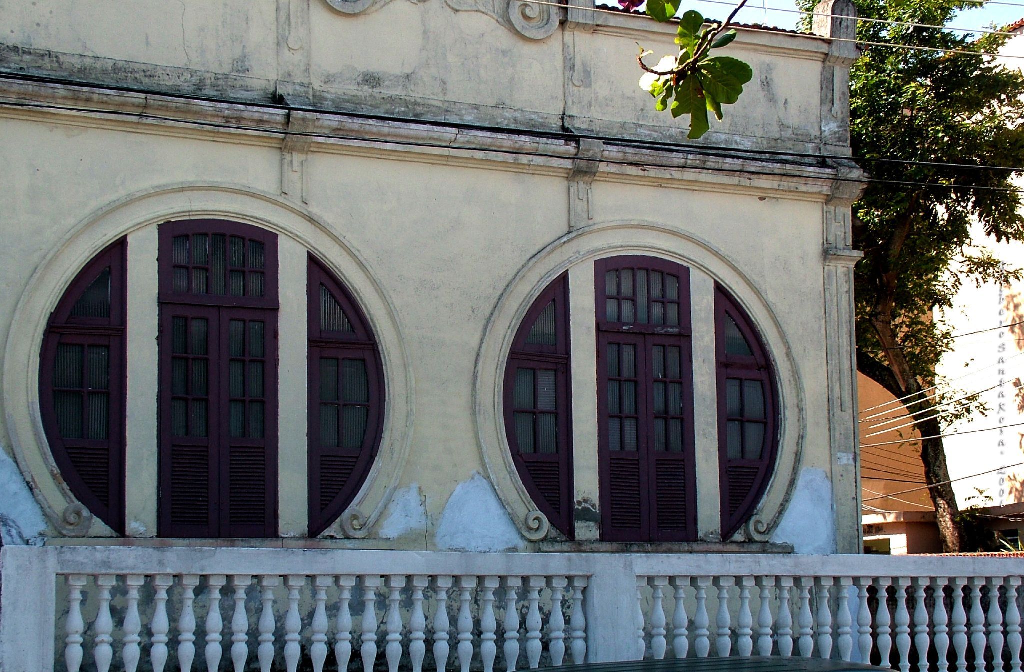 an old building with arched windows and arched wrought ironwork on it