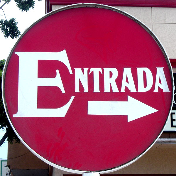 the sign is red and white with white arrows