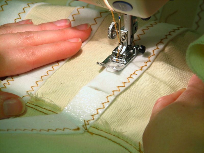 someone is using a machine to sew a garment