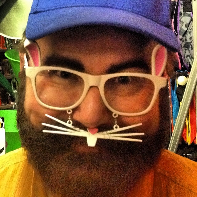 a man wearing glasses and a cat nose mustache