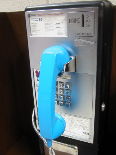 an old fashioned telephone with a blue dial on it
