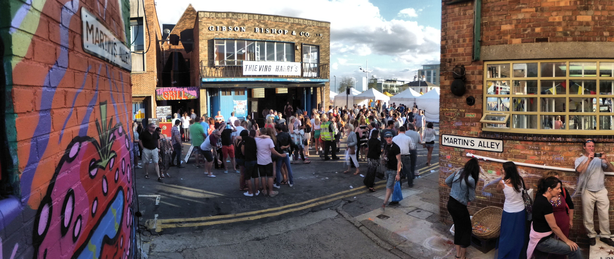 people standing outside of buildings that have been painted