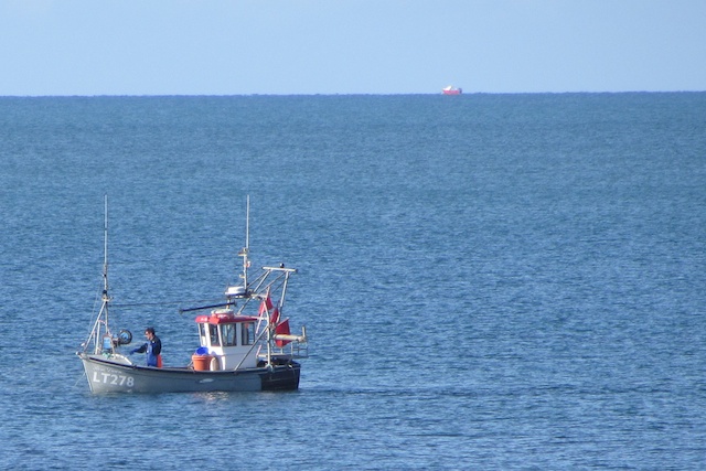 two men on fishing boat out in the water