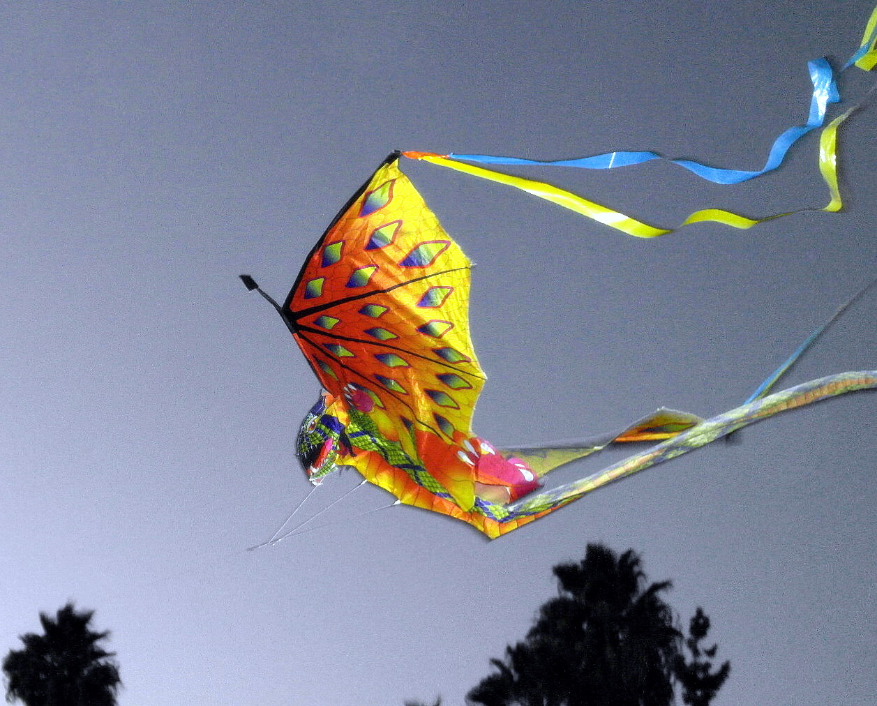 a kite is being flown by a tree