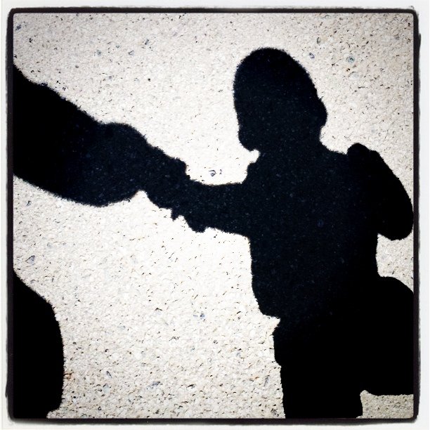 a person putting a fist on their shadow