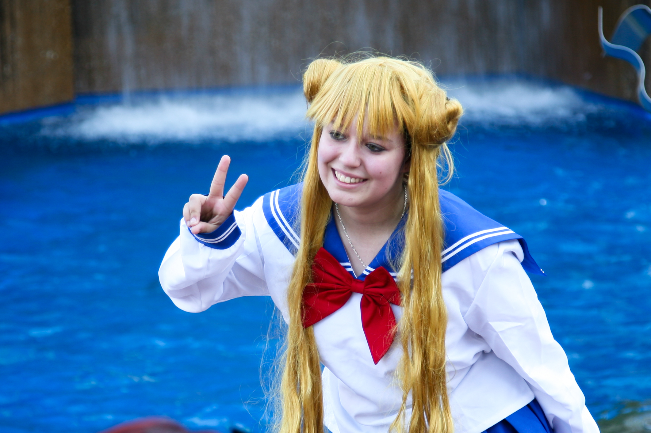 a woman dressed up like sailor with her hands in the air