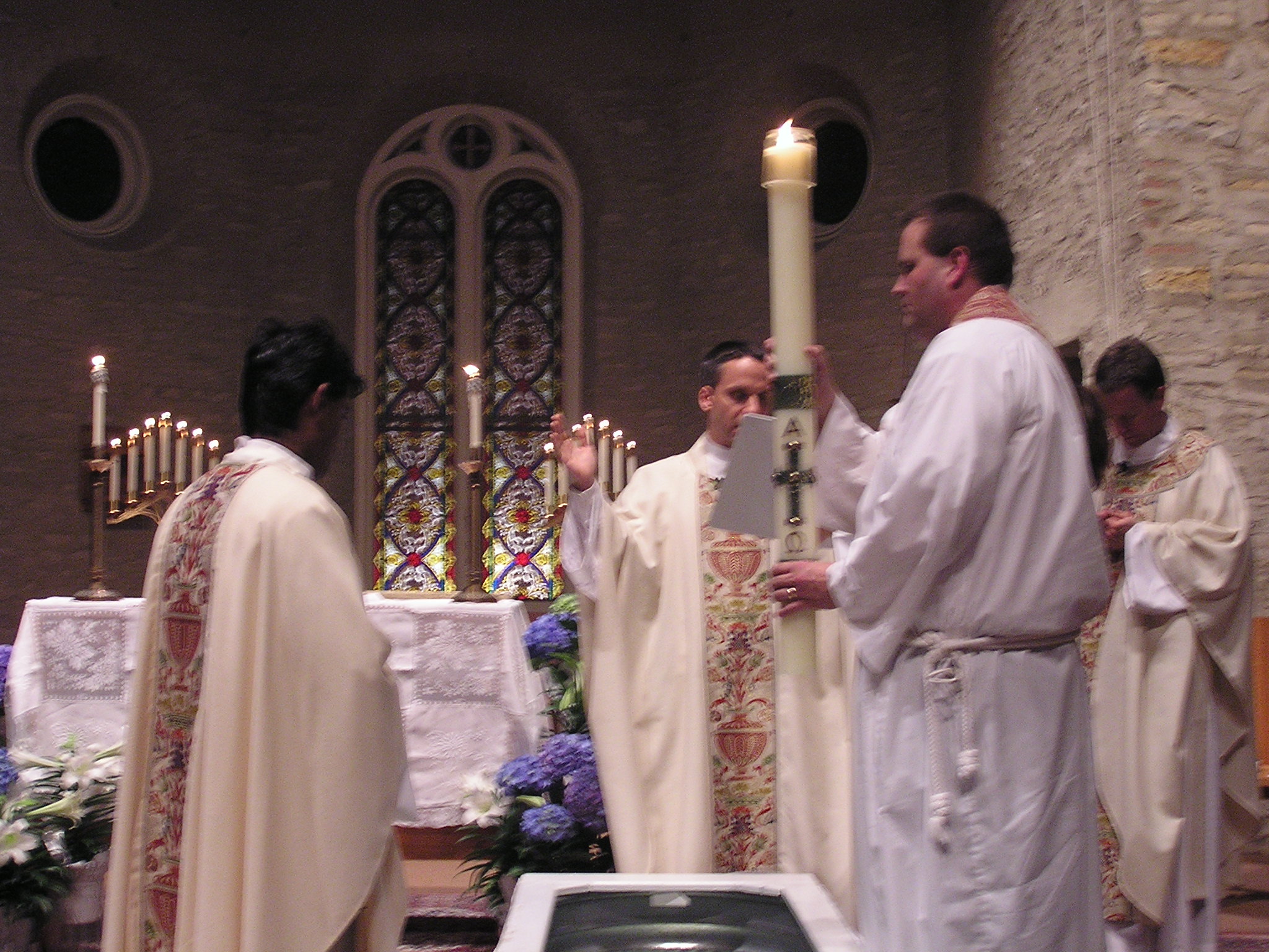 a priest is ordained with people dressed in white