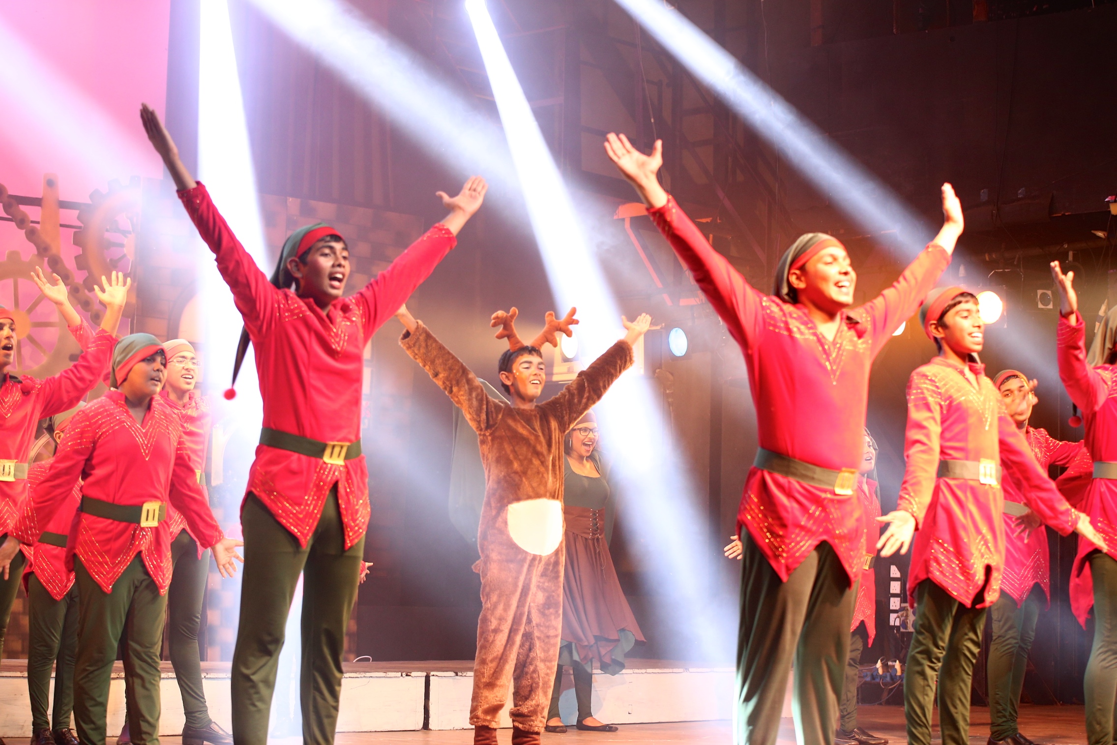 a group of people singing in line during a performance