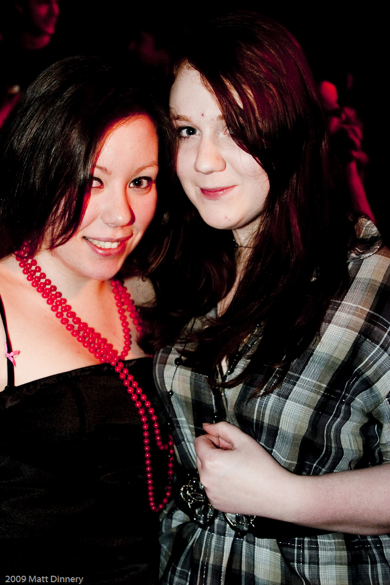 two beautiful young women standing next to each other