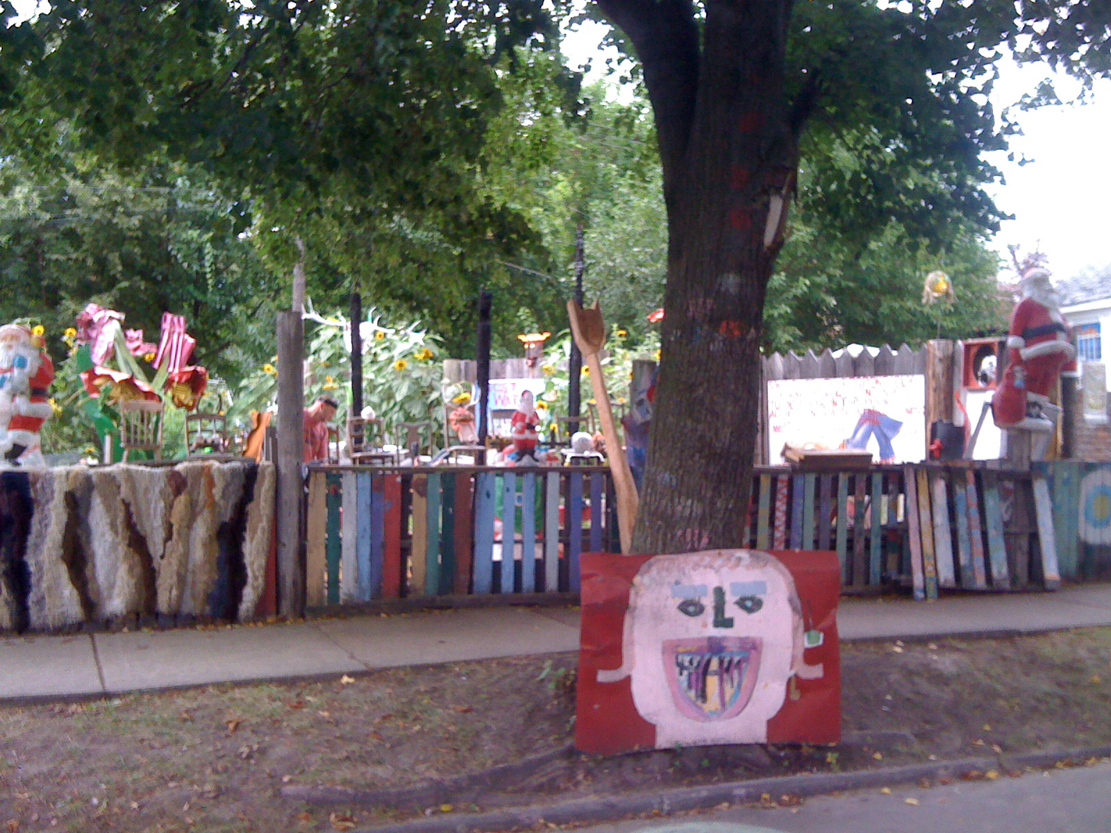 colorfully painted, paper cutouts and tree in foreground