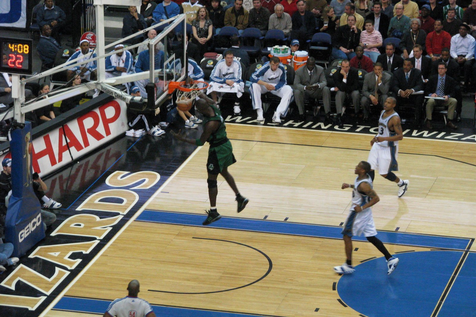 an image of a basketball game with the hoop being blocked