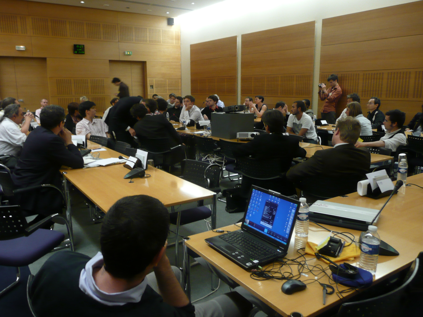 an audience of students in a seminar room sitting at their desks