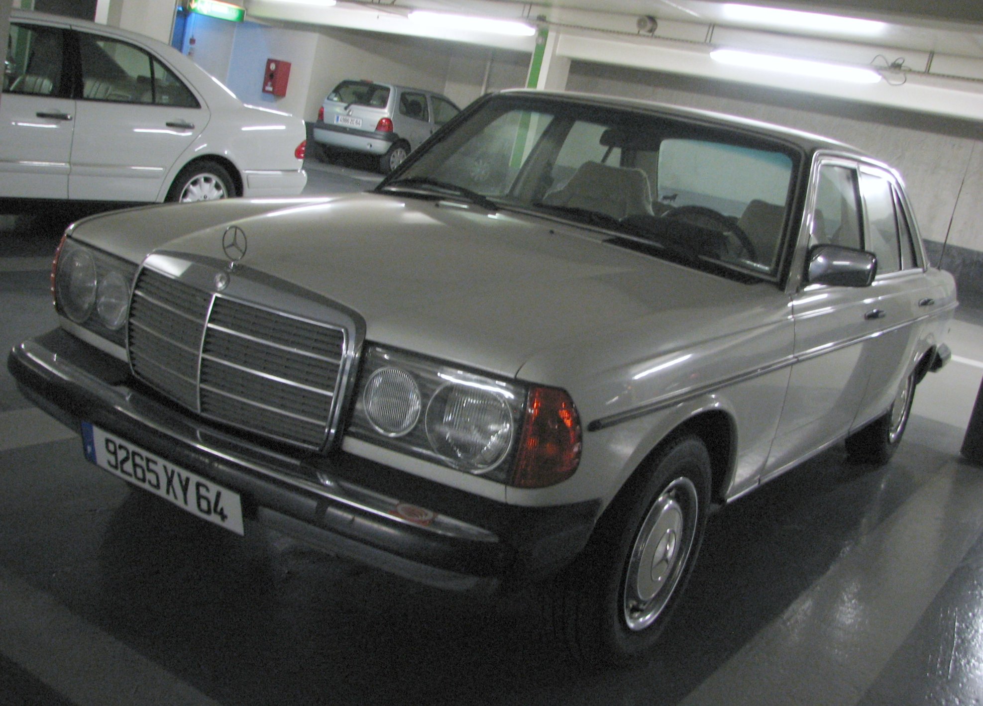 the front of an old mercedes in a garage