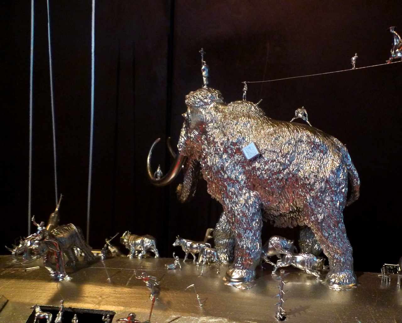 an elephant figurine is made out of many silver objects