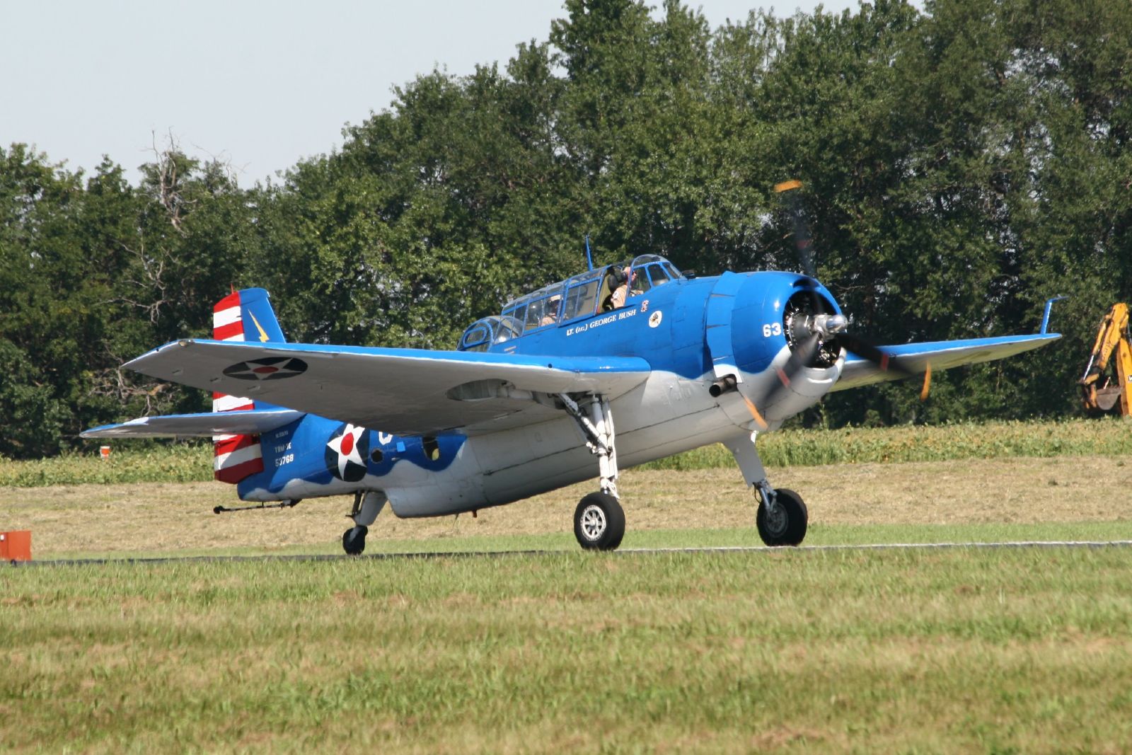 an airplane sitting on the ground in a field