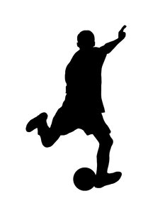 the silhouette of a young man kicking a soccer ball