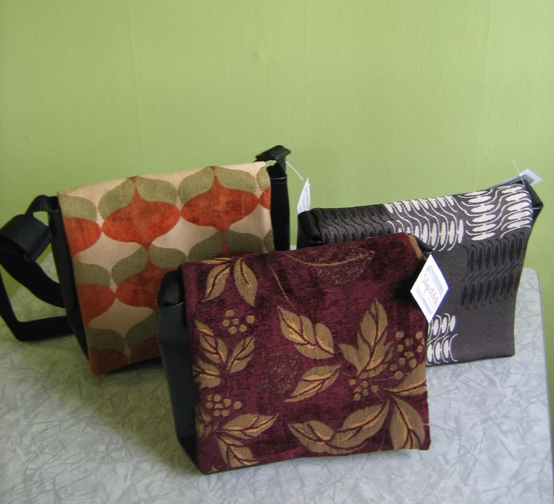 three purses with a green wall in the background