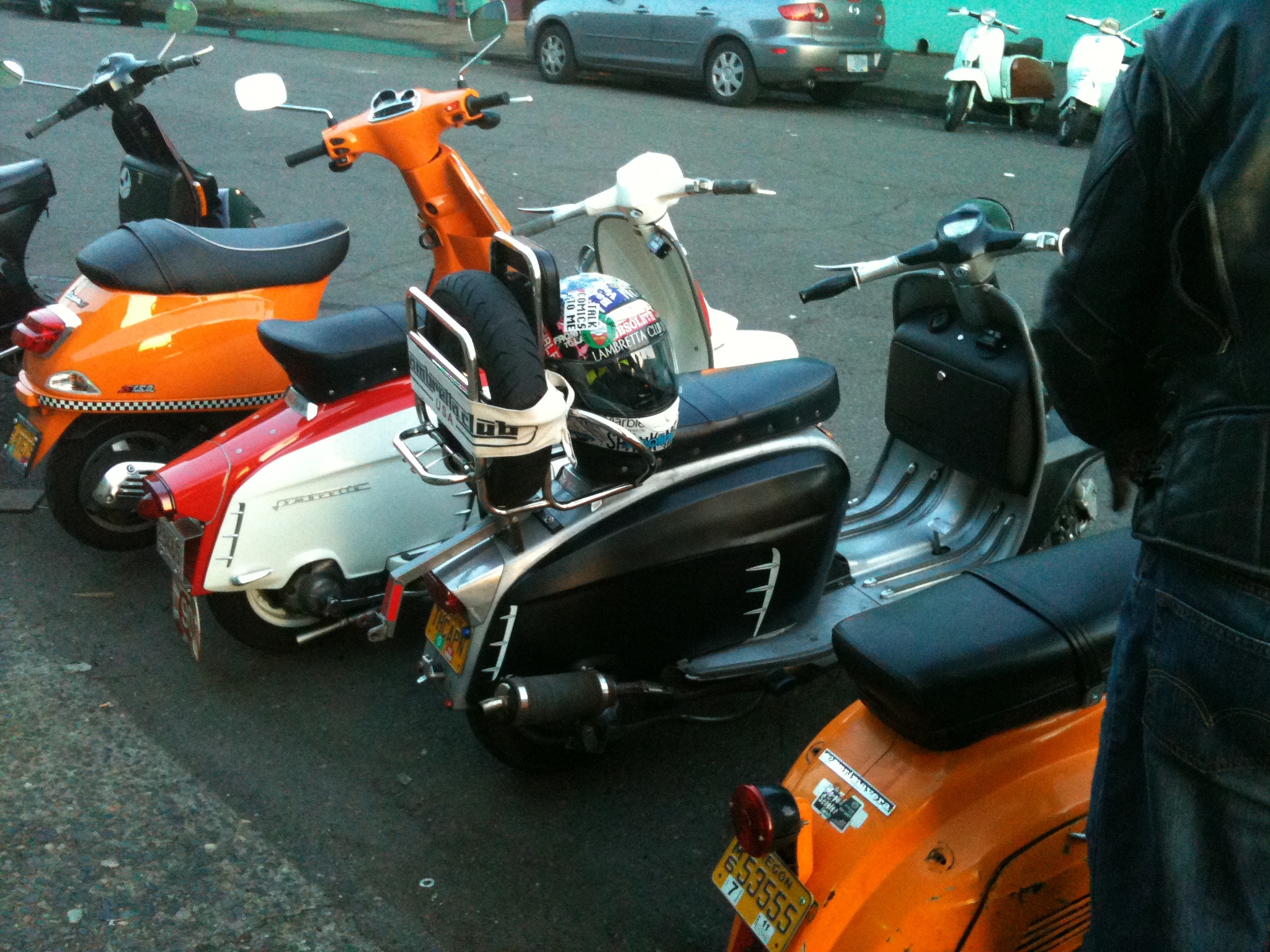 motor scooters and mopeds parked side by side in traffic