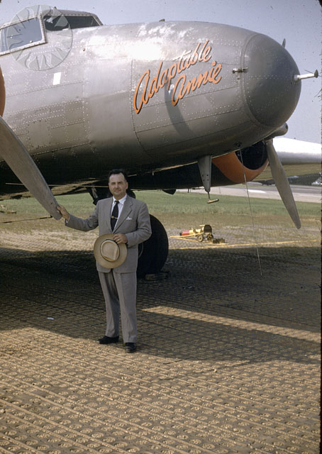 a man stands near an airplane on the tarmac