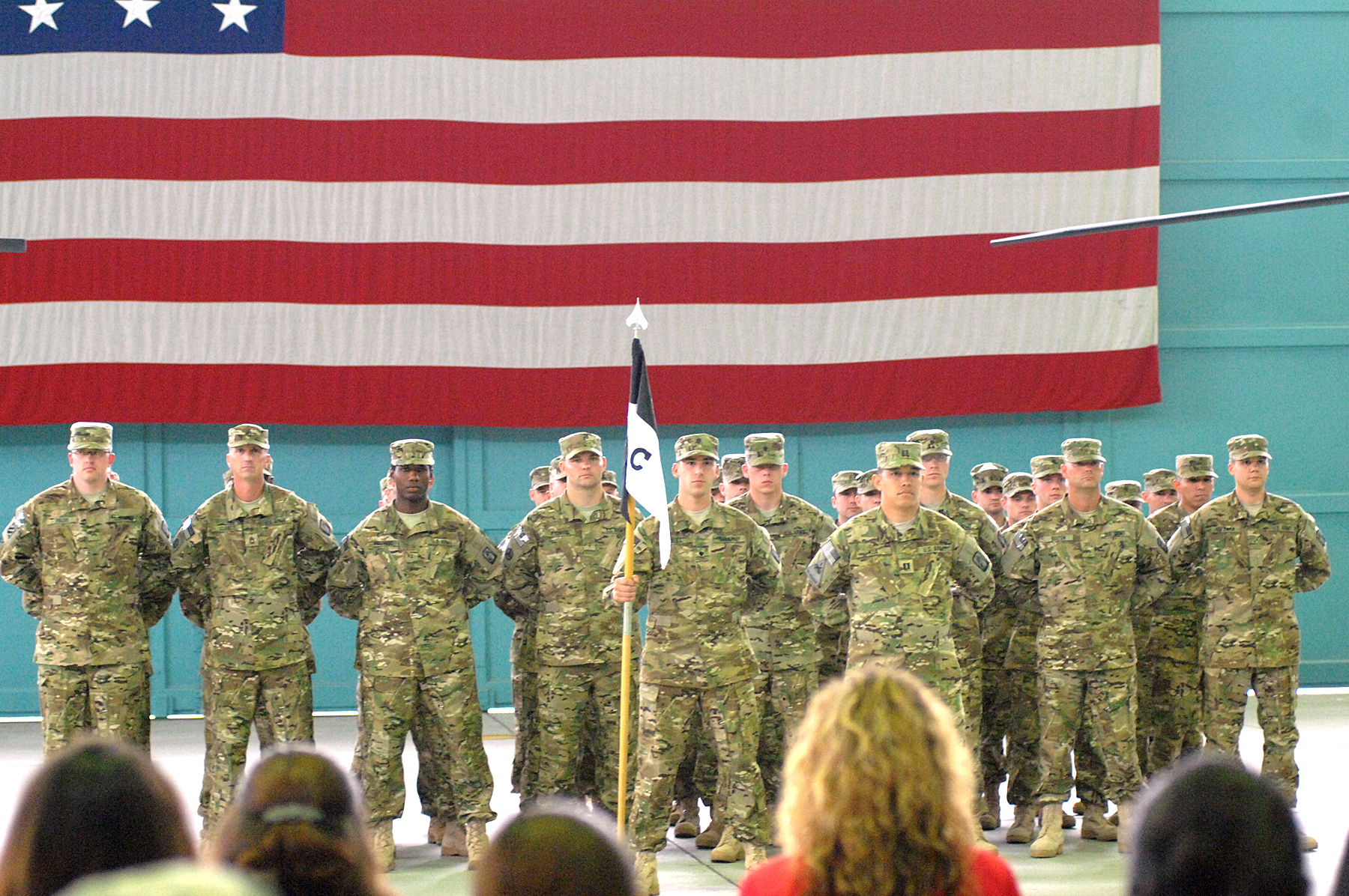 a group of people are standing in front of a flag