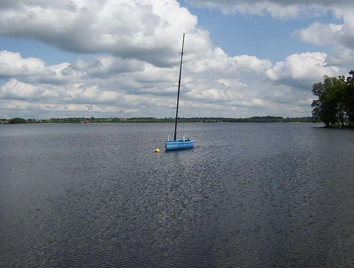 there is a small sail boat in the lake