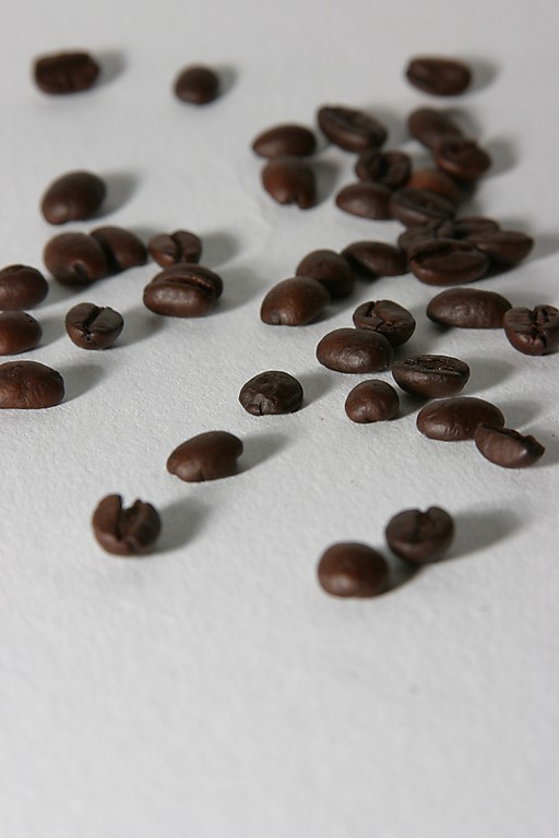 some coffee beans are falling onto the table