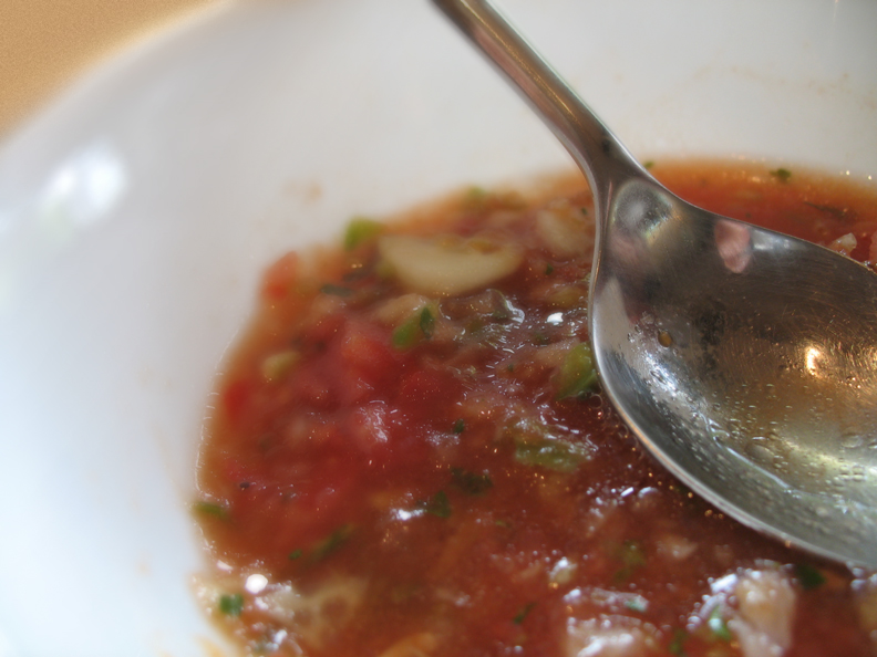 a spoon sitting inside of a bowl of food