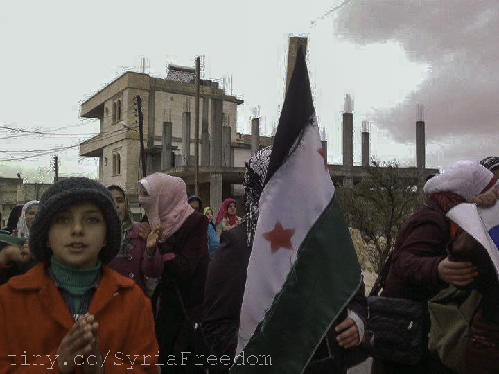 a group of women carrying national flags standing outside