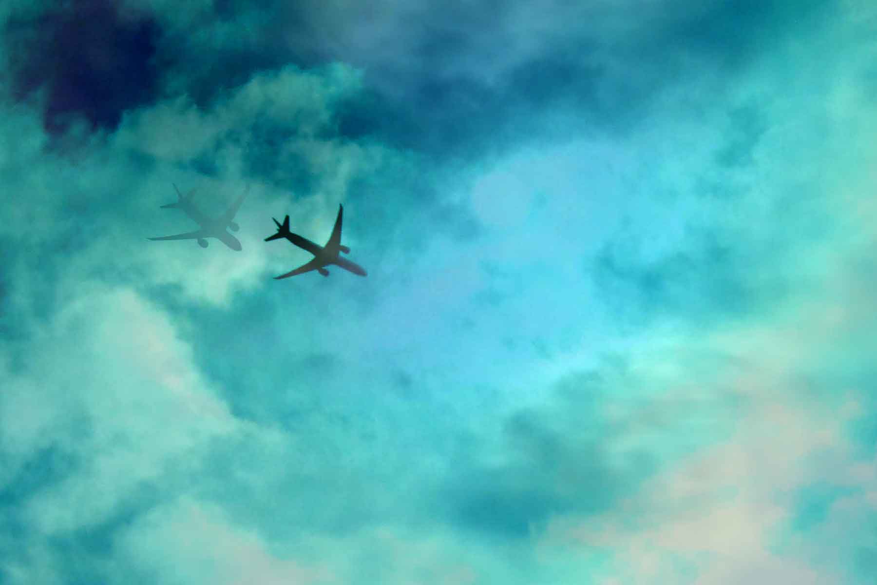 an airplane is flying in the sky with clouds
