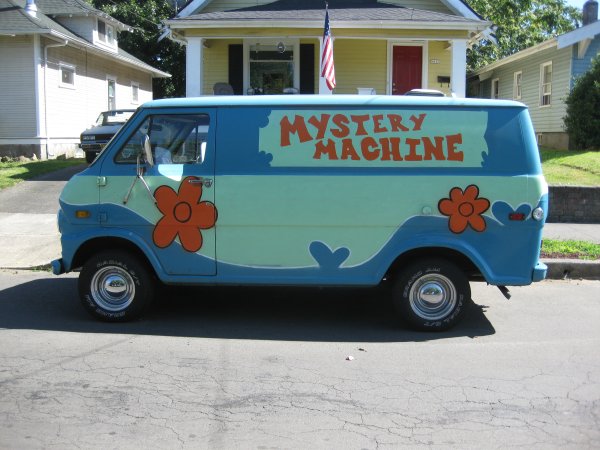 a blue van is parked on the street