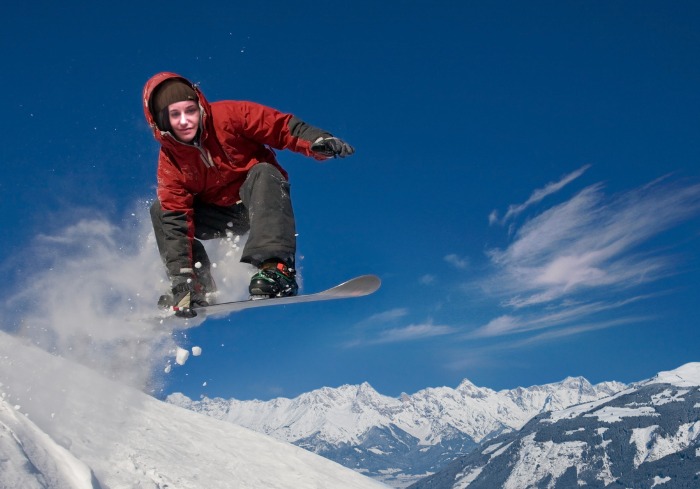there is a snowboarder jumping a snowy mountain
