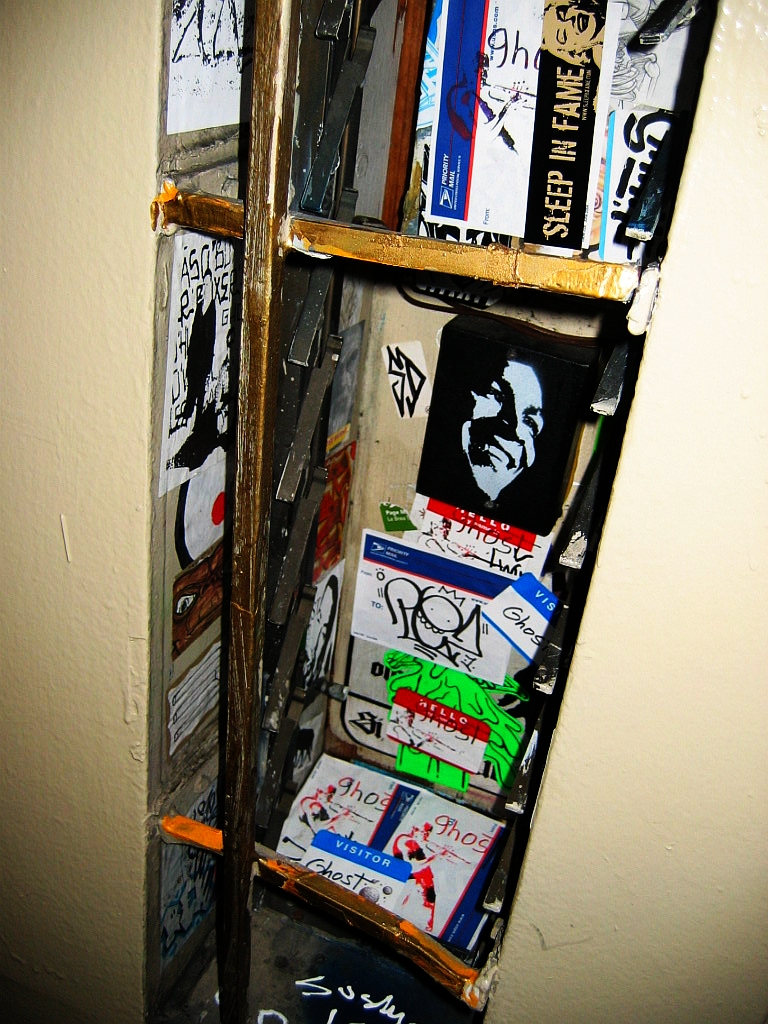 skateboards sitting on a shelf against a wall