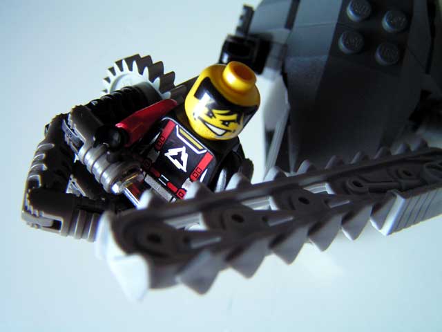 a closeup po of a lego man holding a knife blade