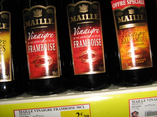 three bottles of wine are on a shelf