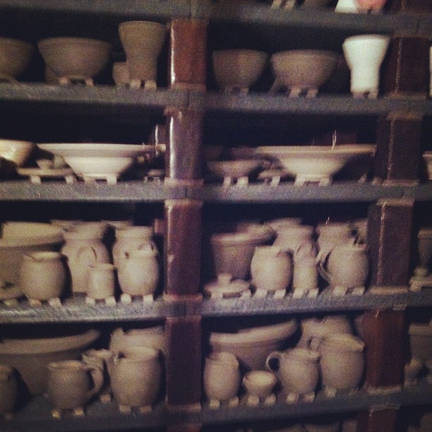 a rack full of ceramic objects on shelves