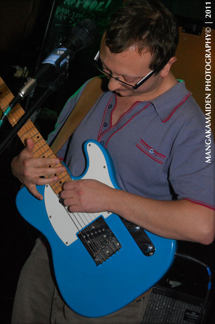the young man is playing an electric guitar