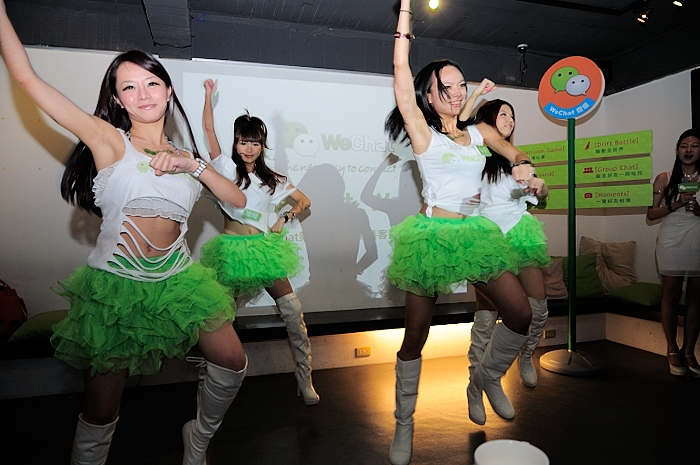 a group of women in a room with green tutu skirts