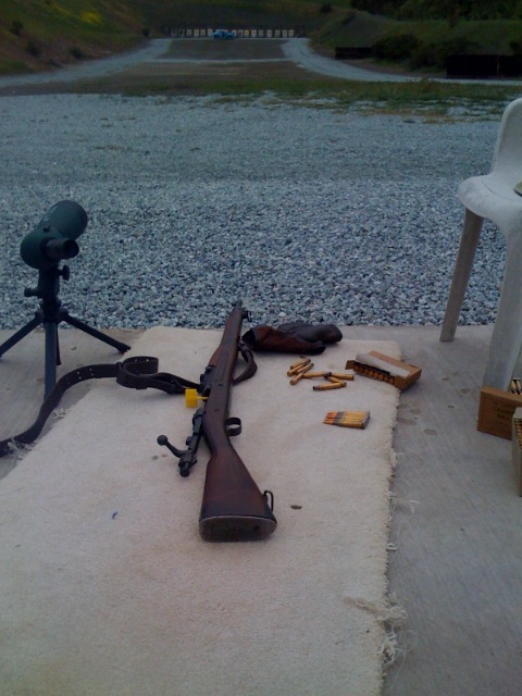 gun lying on the ground next to chair
