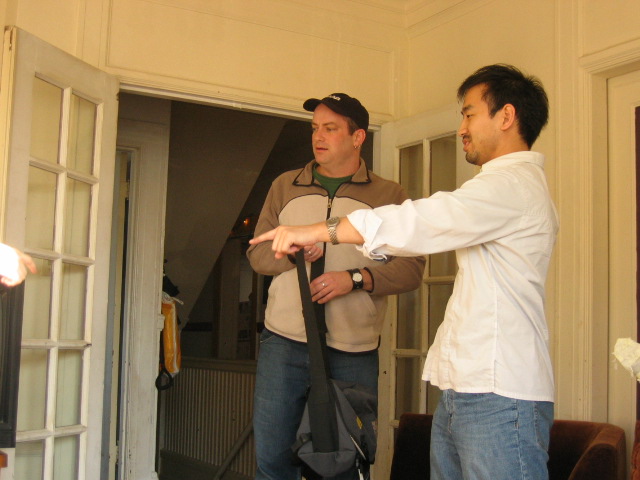 two men in a room are looking in an open door
