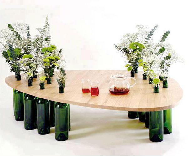 a table with four glass vases and six bottles