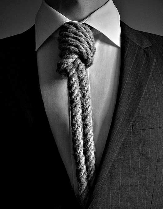 a man in a suit with a large rope on his tie