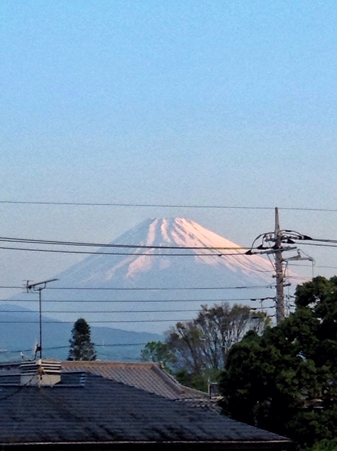 there is a large mountain in the distance with power lines