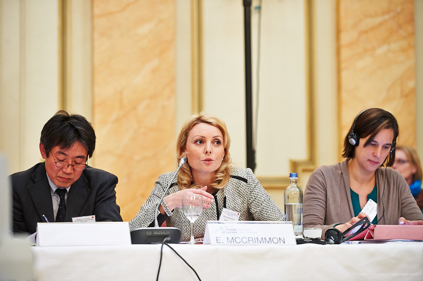 a meeting between two women and two men sitting at a table