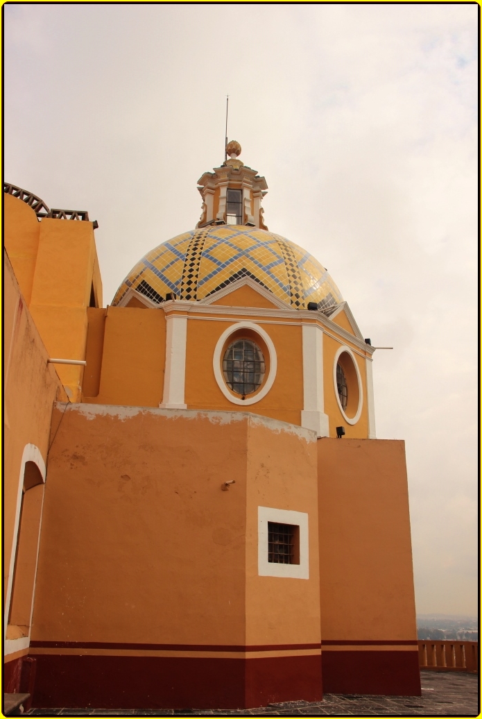 a church building with a golden dome and yellow and white colors