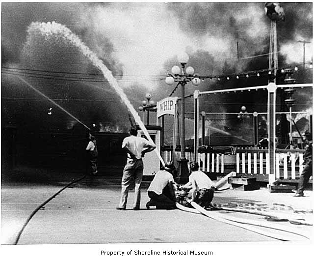 a fireman is spraying water at the men